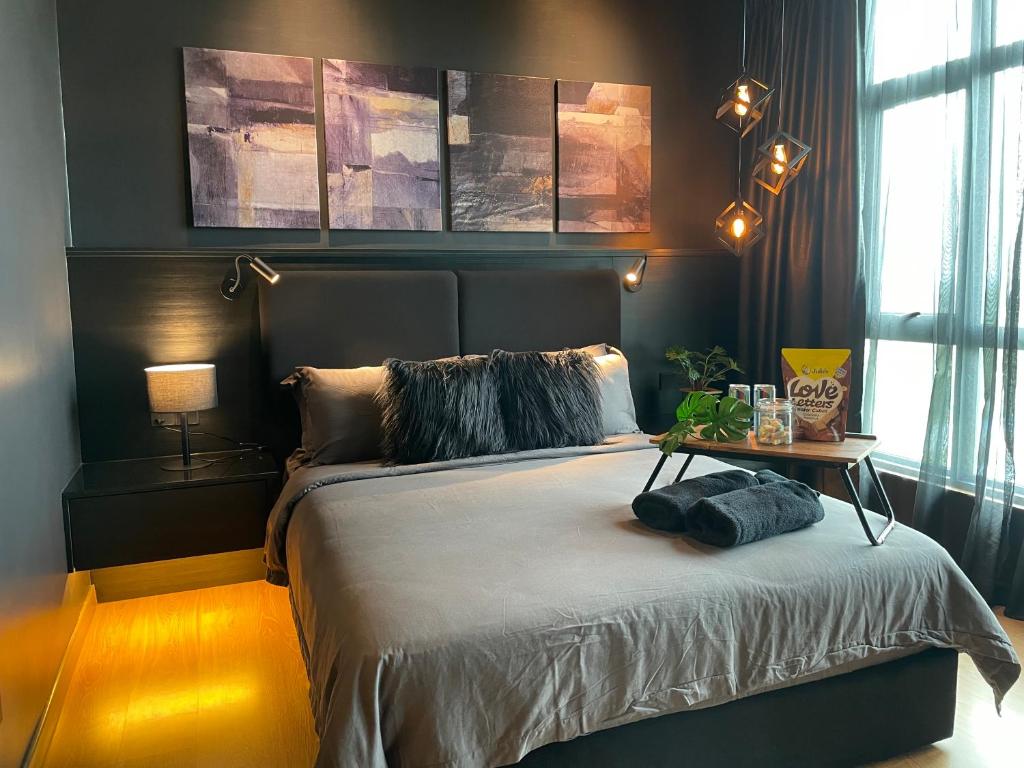 a bedroom with a bed with a table on it at Serene Studio Imperium Residence Kuantan in Kuantan