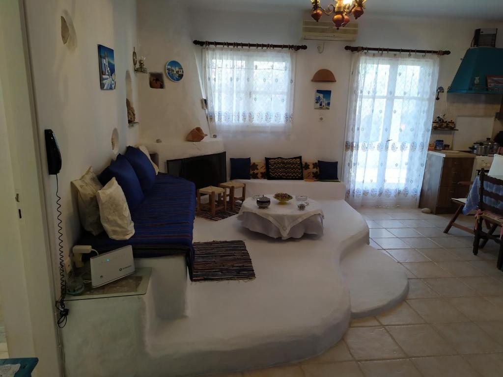 a living room with a couch and a table at Traditional House Marivilla in Mastihari