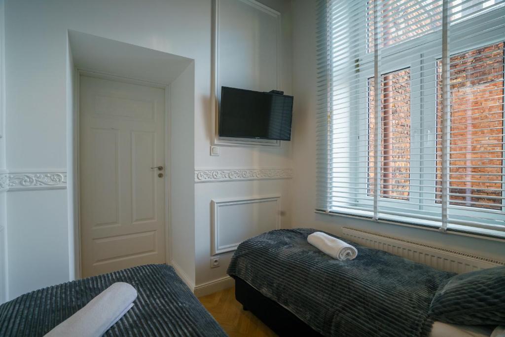 Televízia a/alebo spoločenská miestnosť v ubytovaní Prestige Apartment Rynek Kielce