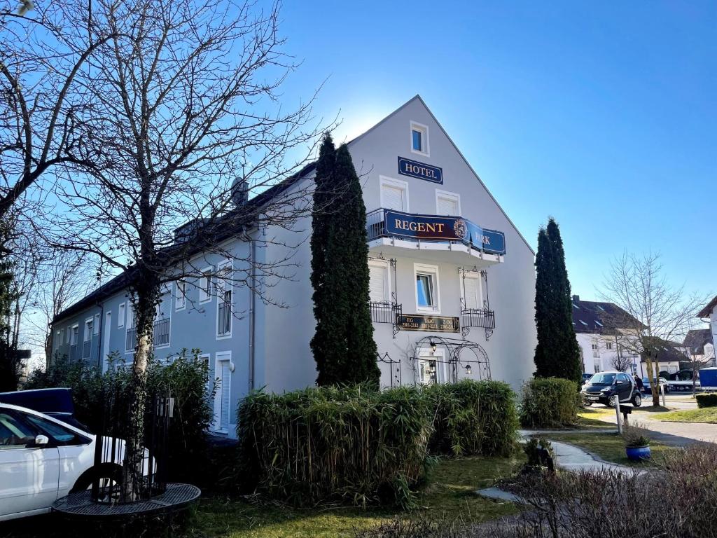 a white building with a sign on it at Runa´s Appartment in Hallbergmoos