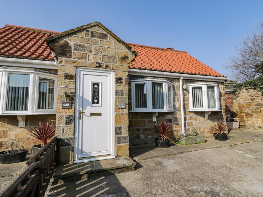 a brick house with a white door at The Stables in Redcar