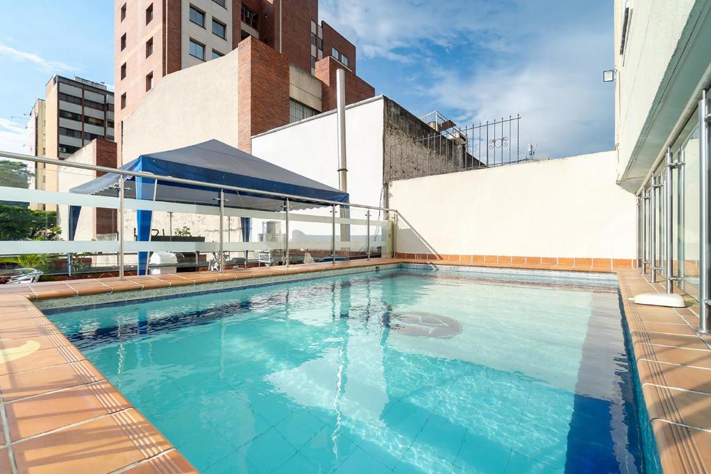 a swimming pool on top of a building at Hotel Plaza Versalles in Cali