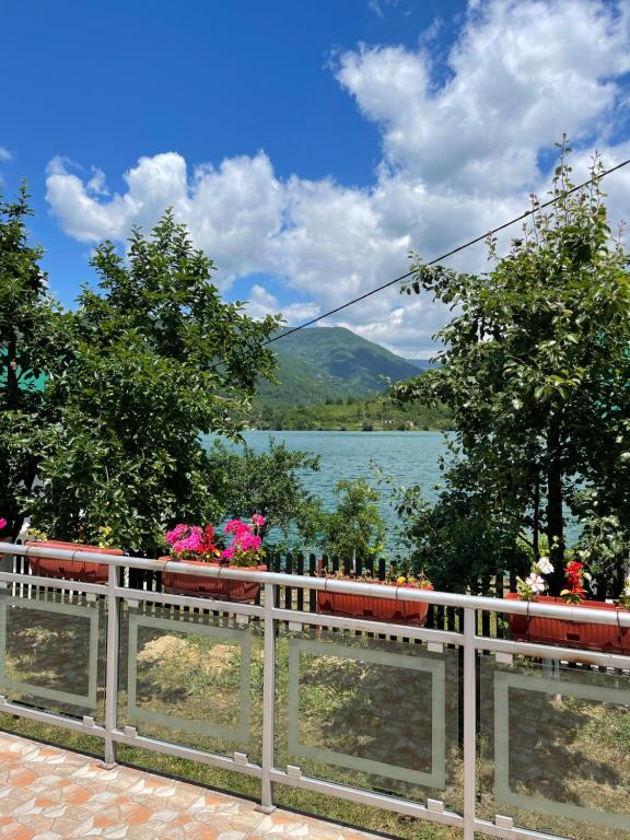 a train on a fence with a view of a lake at Montana Apartmani in Konjic