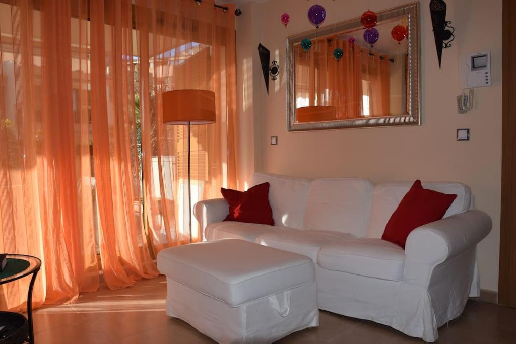 a living room with a white couch and red pillows at Luxury 1 bedroom private apartment - Dog friendly! in Finestrat