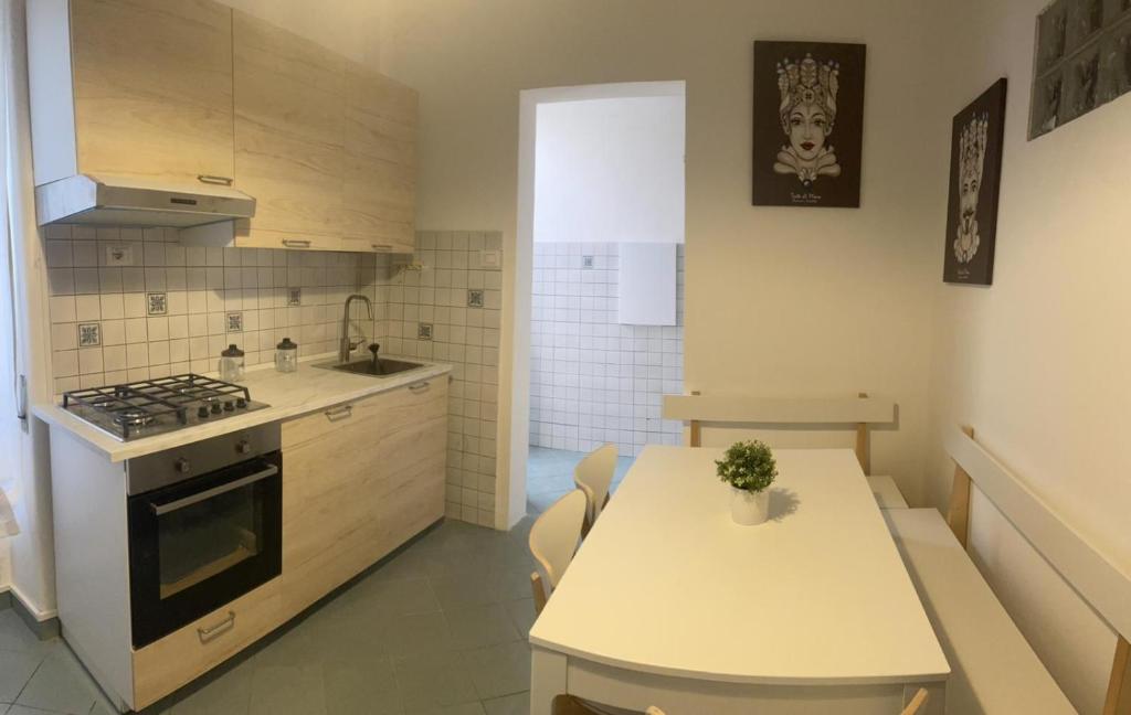 a kitchen with a table and a stove top oven at Franchetti House in Catania