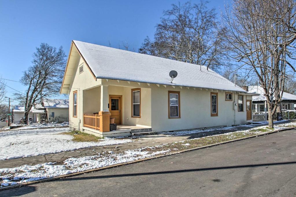 a small white house with snow on the ground at Pet-Friendly Hot Springs Home with Large Yard! in Hot Springs