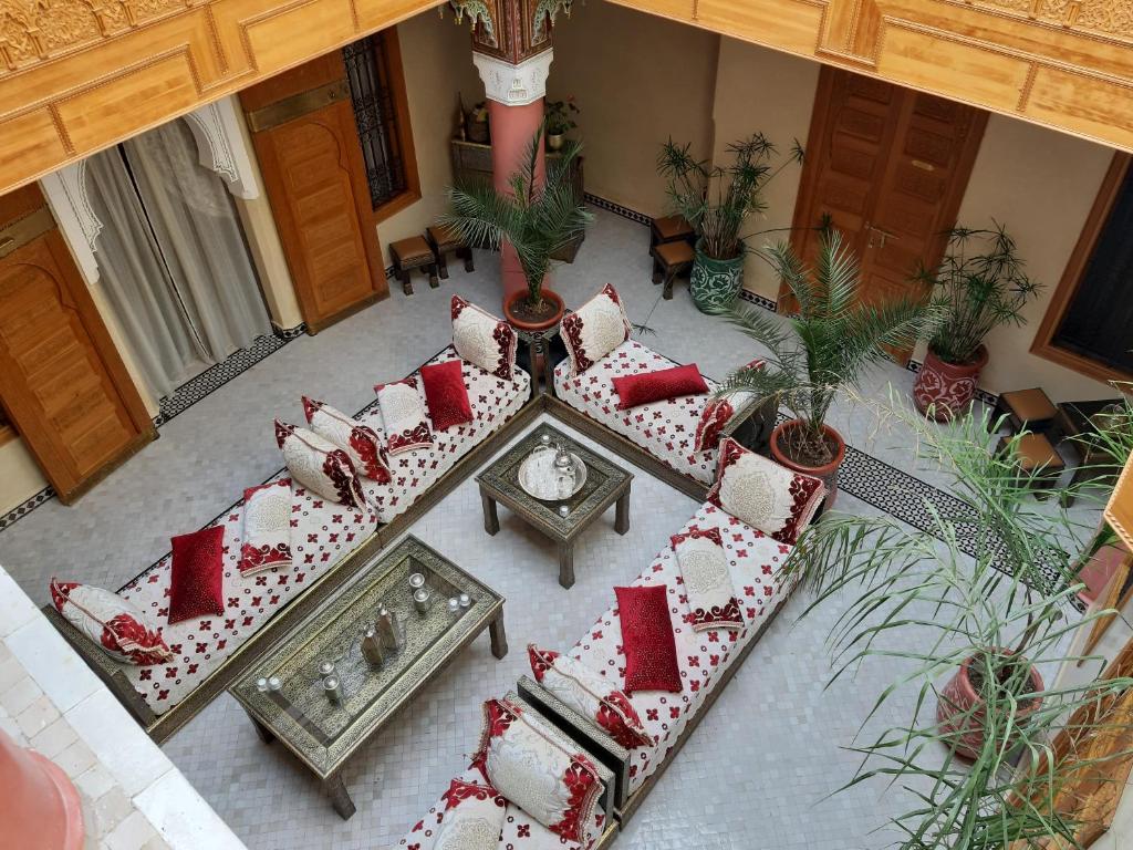 an overhead view of a living room with red and white pillows at Riad Miral in Marrakesh