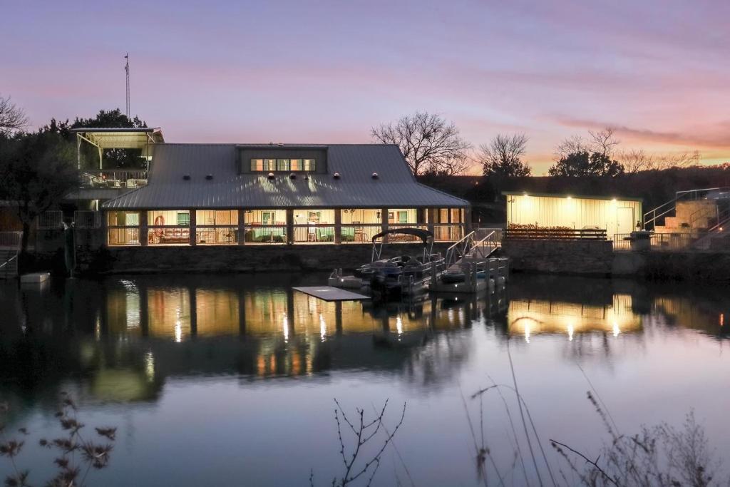 una gran casa en el agua con un edificio en Lodge on Lake Godstone, en Jacksboro