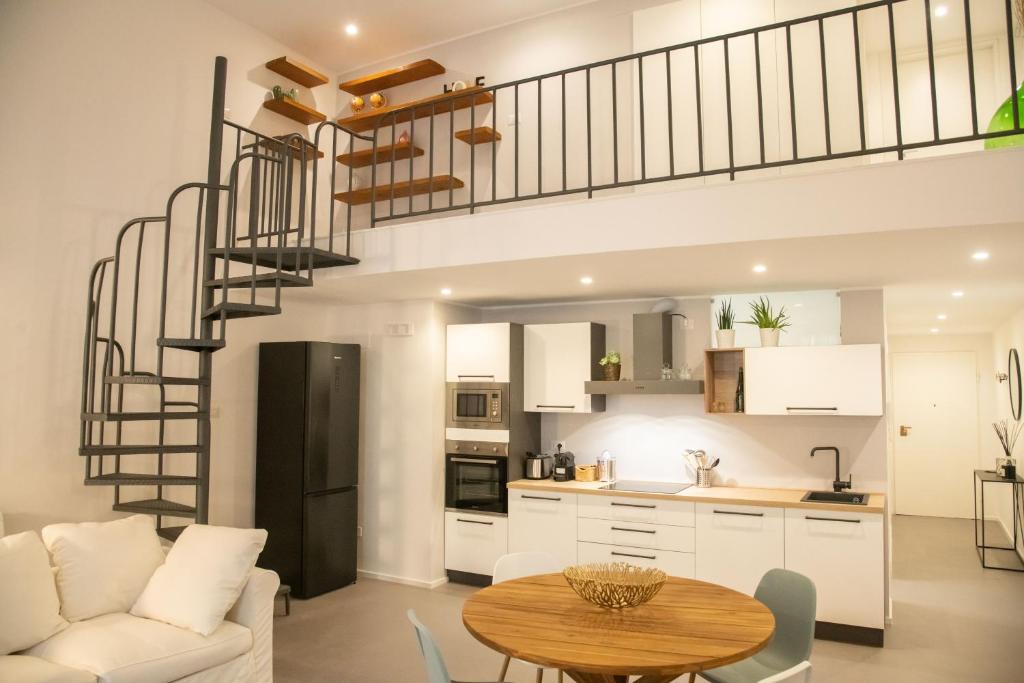 a kitchen and living room with a spiral staircase at Casa Sant'Orsola - Appartamento nella città antica in Molfetta
