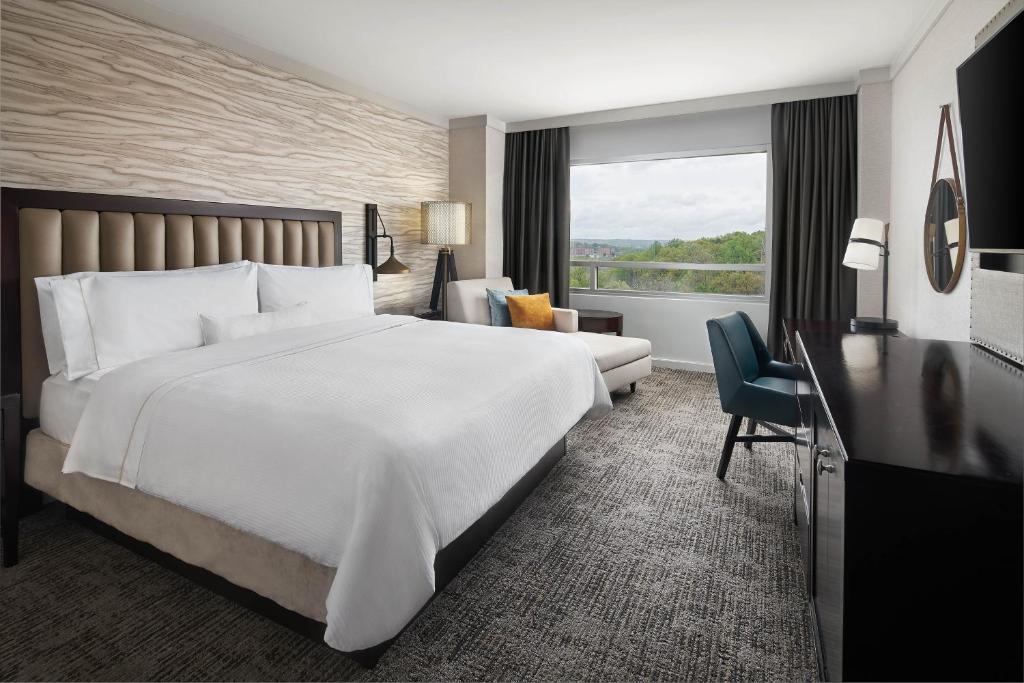 a hotel room with a large white bed and a window at The Westin Baltimore Washington Airport - BWI in Linthicum Heights