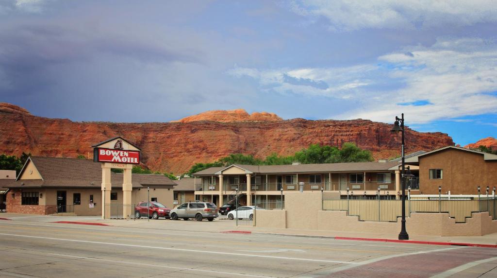 a parking lot with a stop sign and a building at Bowen Motel in Moab