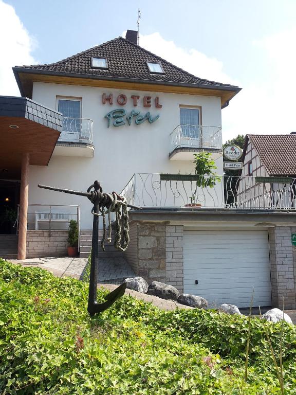 a statue in front of a house at Weigands Hotel Peter in Reinhardshagen