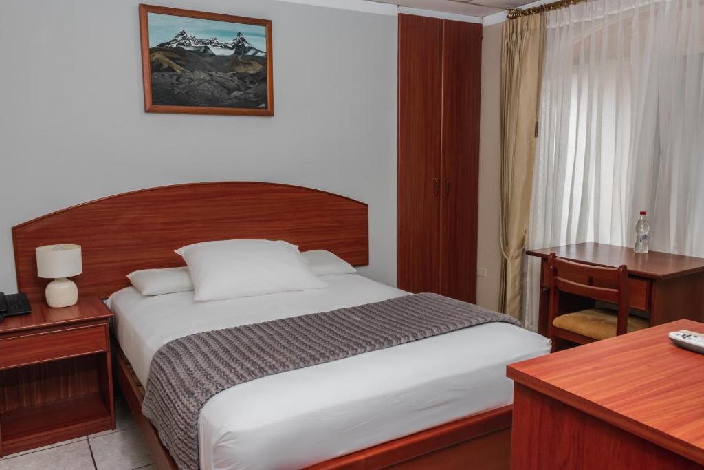 Postel nebo postele na pokoji v ubytování Grand Hotel Machala
