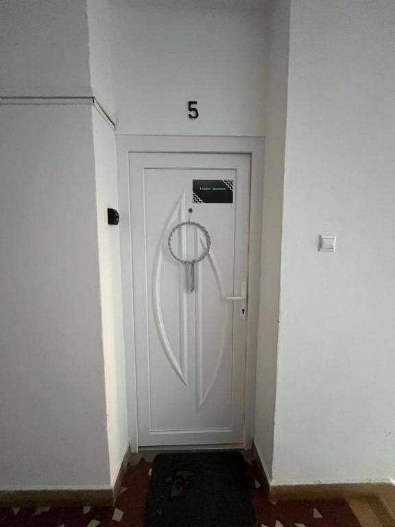 a white door with the number on it at Vándor Apartman in Veszprém