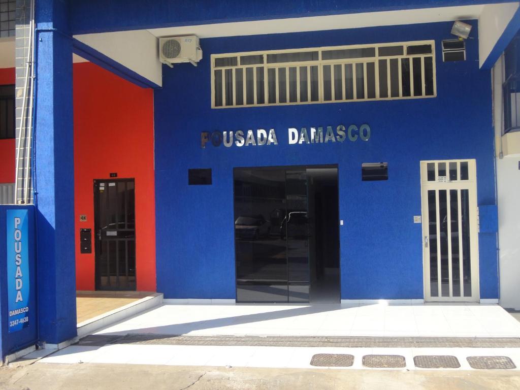 a blue and red building with a usda diabetes sign on it at Pousada Damasco in Brasilia