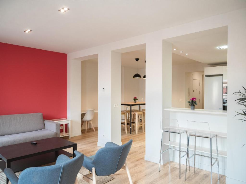 a living room with a couch and chairs and a table at Slow Suites Luchana in Madrid