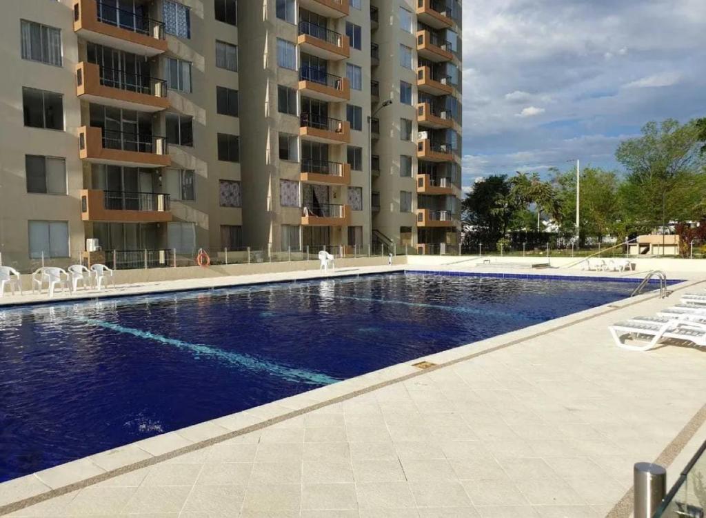 a large swimming pool in front of a building at Mango Home in Ricaurte