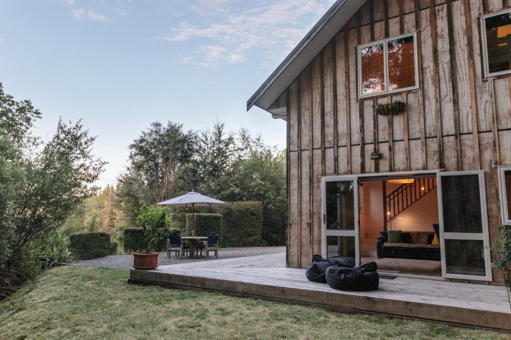 a house with a porch and a patio at Beech Hill - Pet Friendly Holiday Home in Tasman