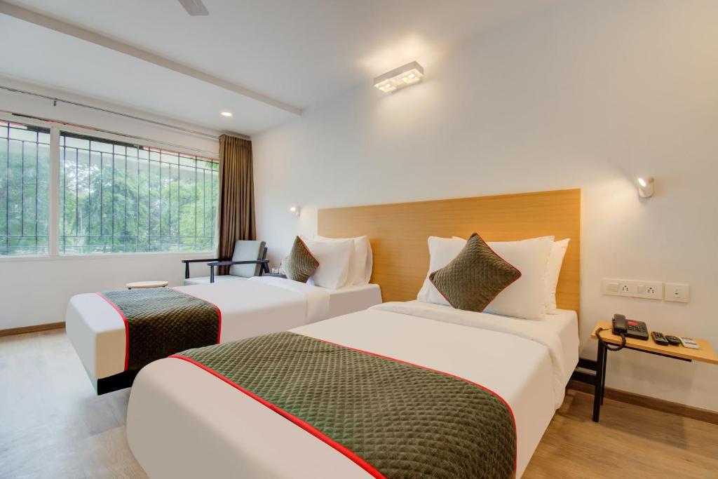 Postel nebo postele na pokoji v ubytování Hotel Maitrayee