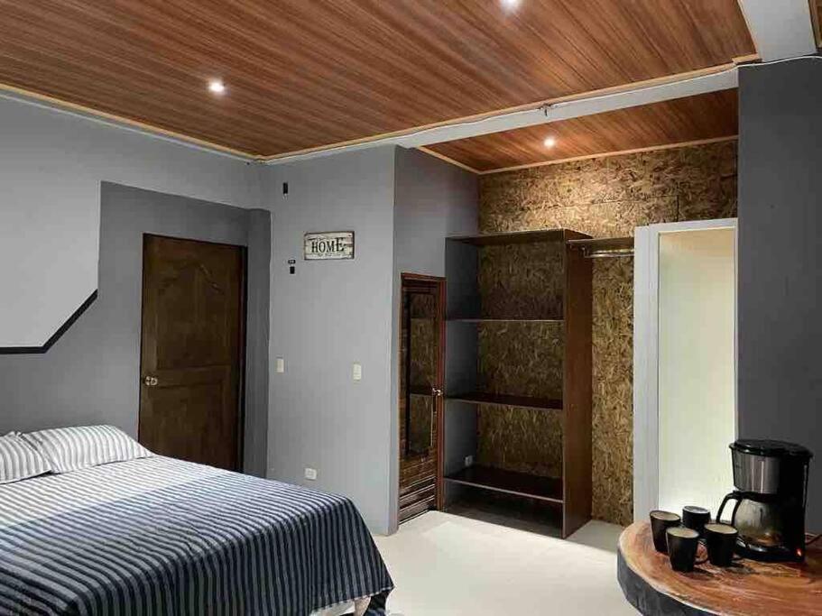 a bedroom with a bed and a wooden ceiling at Hermoso Huehueloft2 con estacionamiento y wifi in Huehuetenango