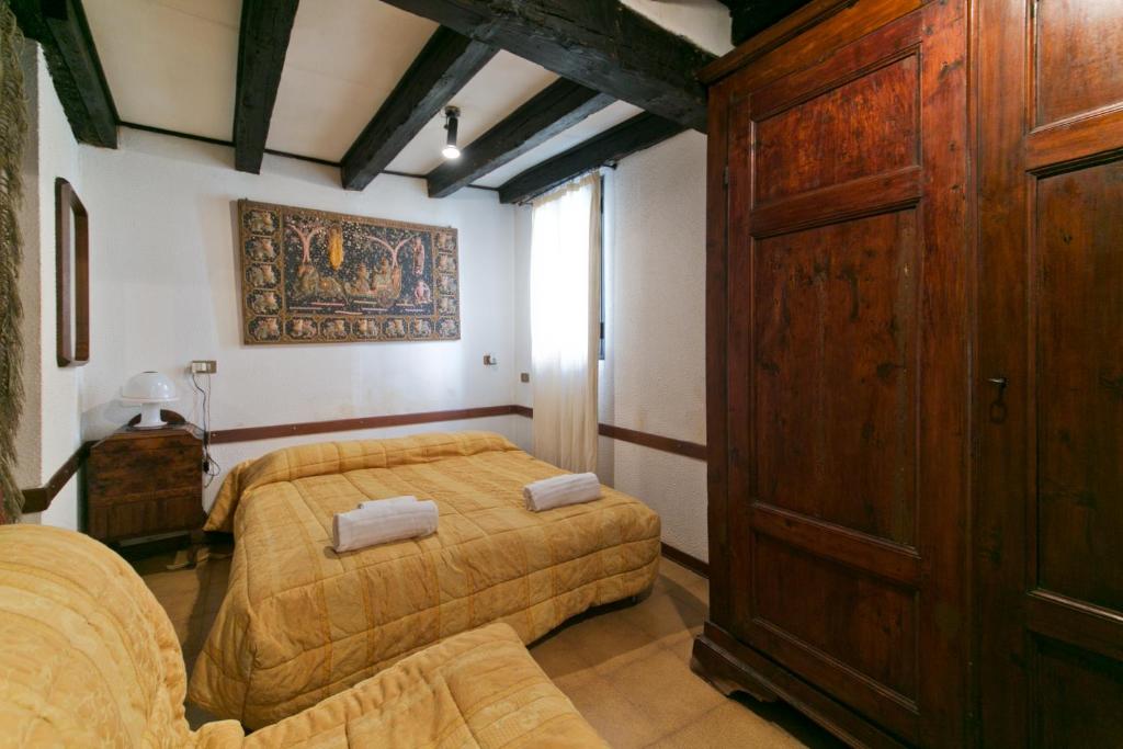 a bedroom with two beds and a wooden cabinet at Ground floor Santa Margherita Apt ac wi-fi in Venice