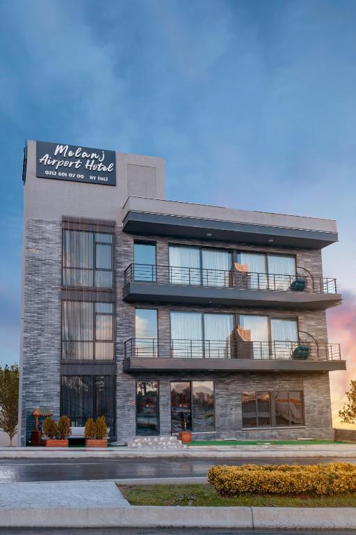 a building with a sign on the side of it at Melanj Airport Hotel in Arnavutköy