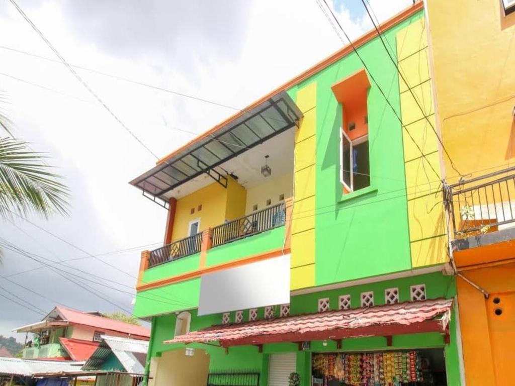 a brightly colored building in a city at Ambon Residence Syariah in Ambon