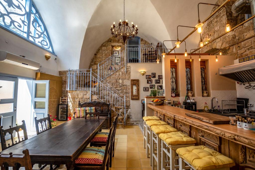 a dining room with a long table and chairs at Arabesque Arts & Residency in ‘Akko