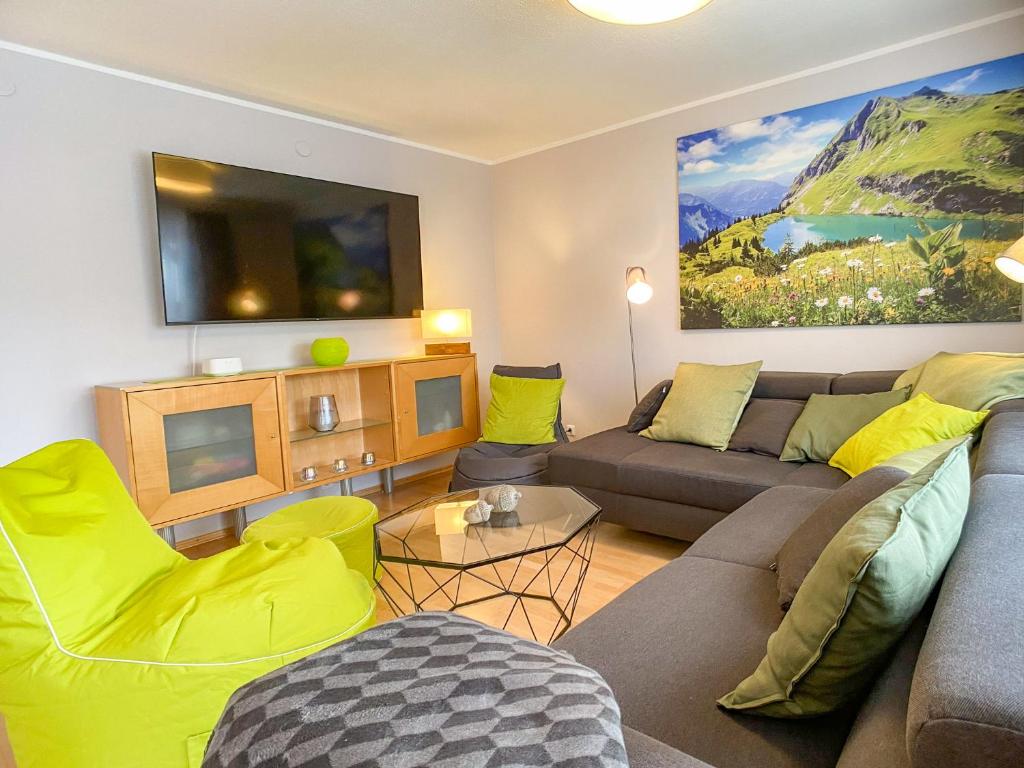 a living room with a couch and a tv at Ferienhaus Frühlingstraße in Sonthofen