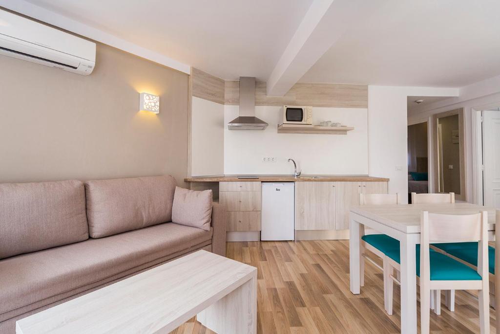 a living room with a couch and a table at Comitas Floramar in Cala Galdana