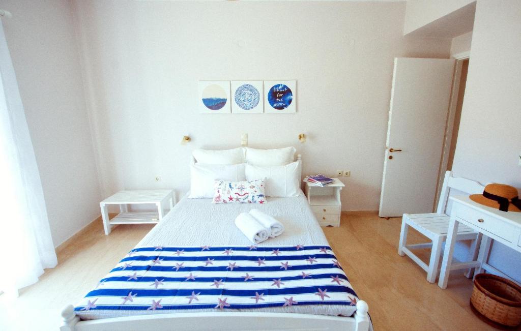 a bedroom with a bed with towels on it at Frida Apartments in Benitses