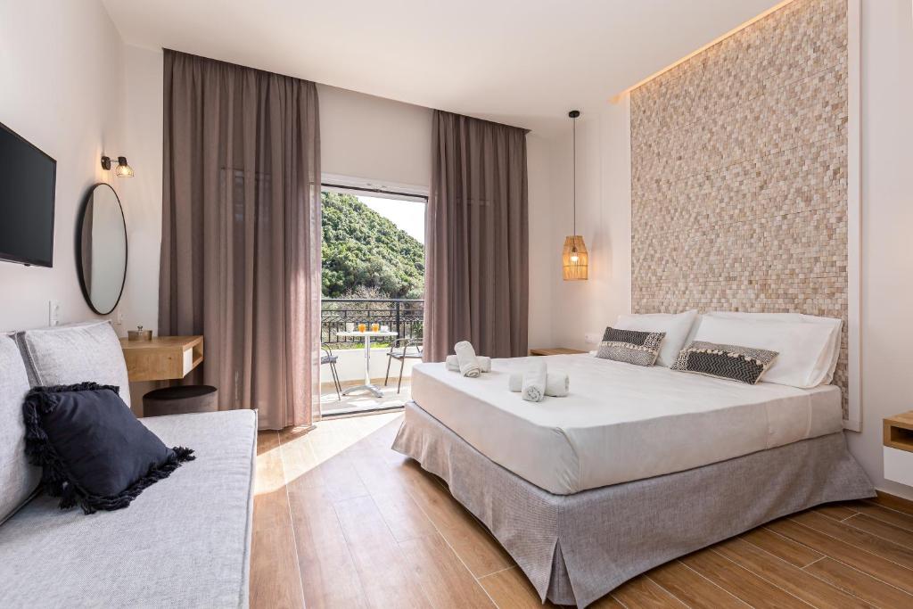 a bedroom with a large bed and a large window at Sea View in Paleokastritsa