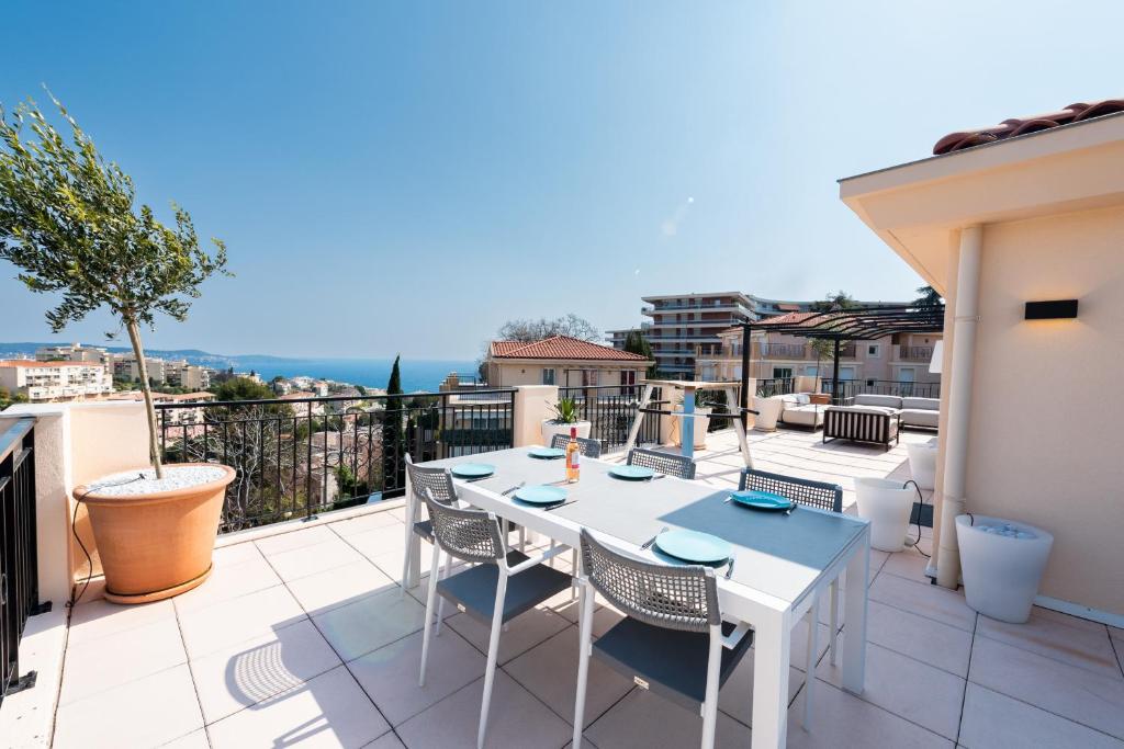 einen weißen Tisch und Stühle auf dem Balkon in der Unterkunft Happyfew Le Lucia in Nizza