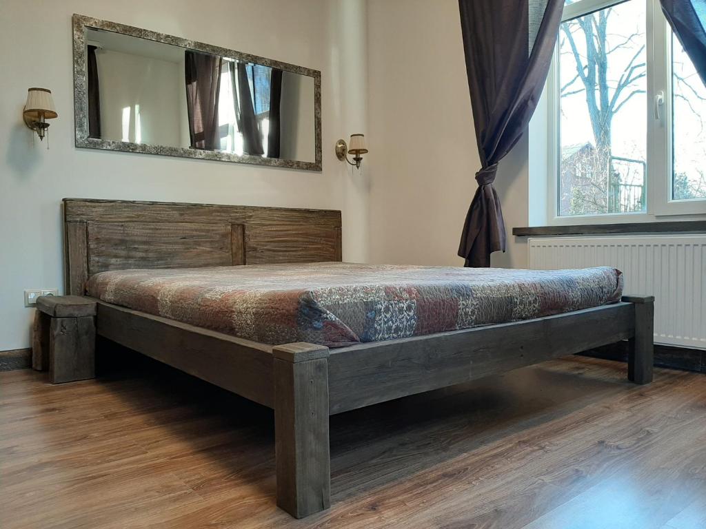 a bed in a bedroom with a large mirror on the wall at Champêtre Déjà Vu in Rīga