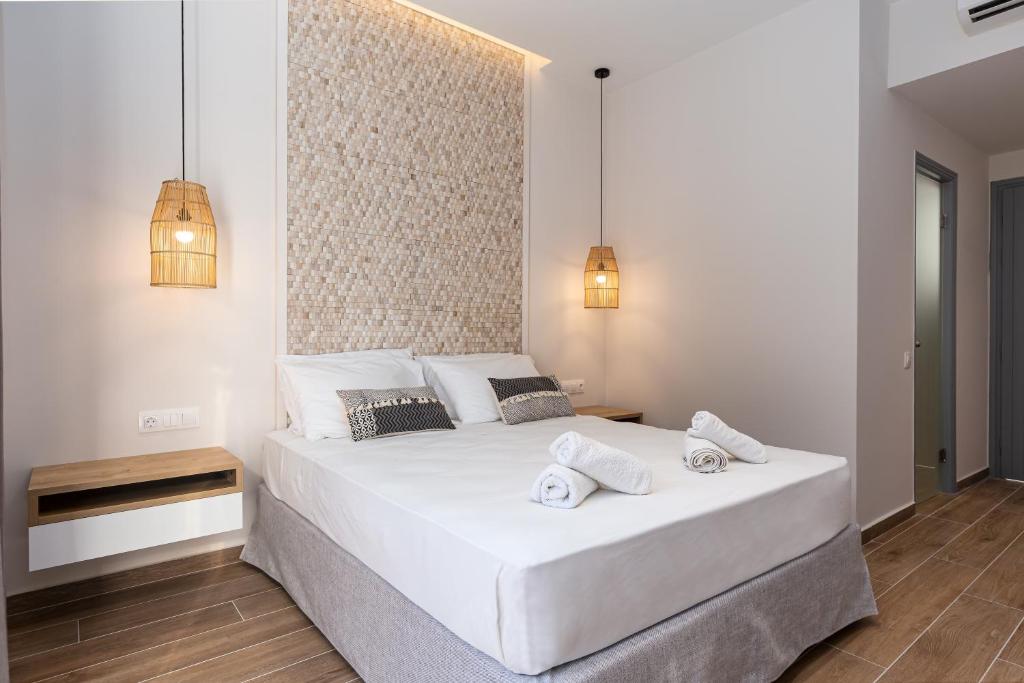 a bedroom with a large white bed with two towels on it at Sea View in Paleokastritsa