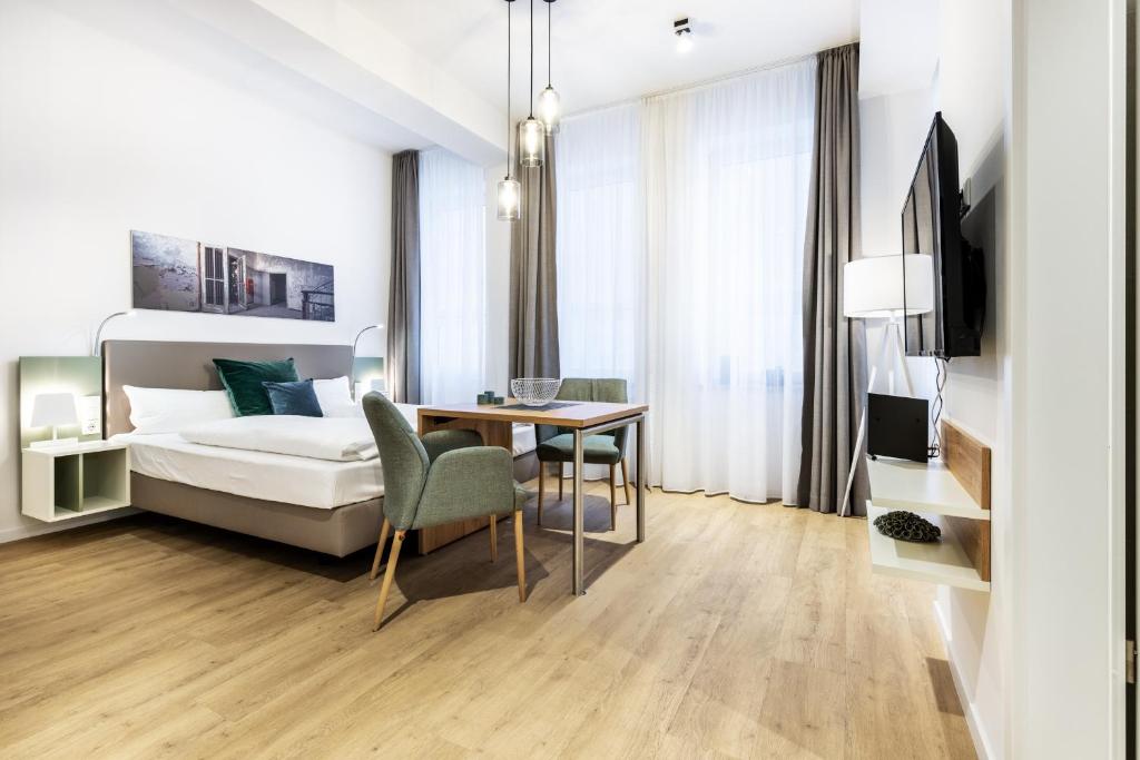 une chambre avec un lit, un bureau et une table dans l'établissement Ferienapartments am Krusespeicher Ferienapartments am Krusespeicher 0-01, à Wismar