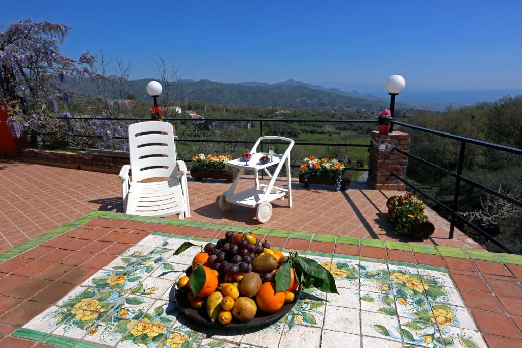 a bowl of fruit sitting on top of a patio at Palmento House Amazing View and Private Mini SPA in Piedimonte Etneo