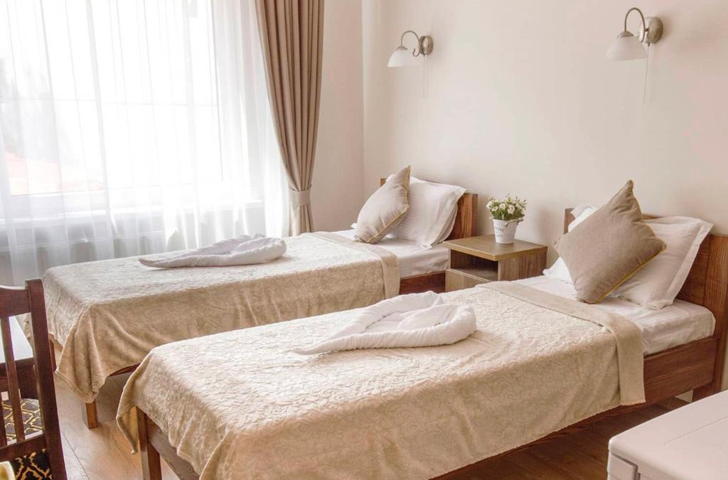 A bed or beds in a room at Mandarin Restoran & Hostel