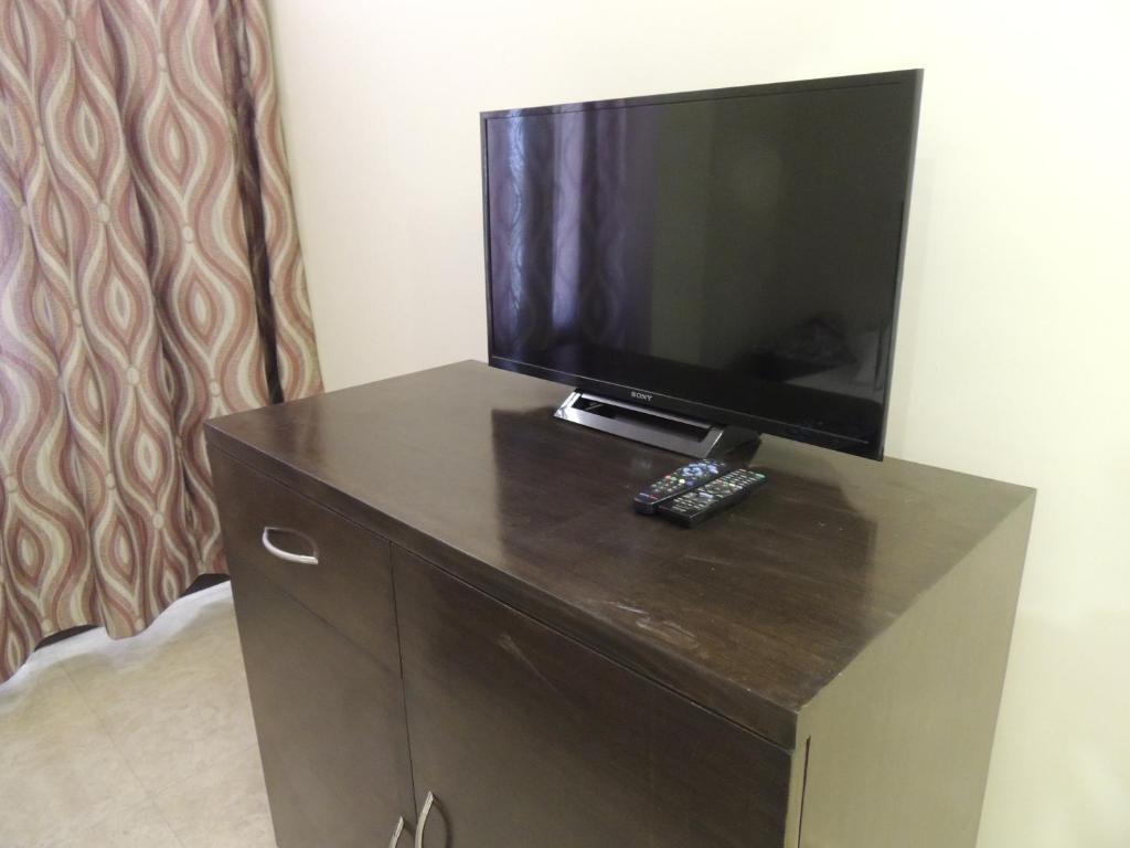 a flat screen tv sitting on top of a dresser at Raj Regency in Jaipur