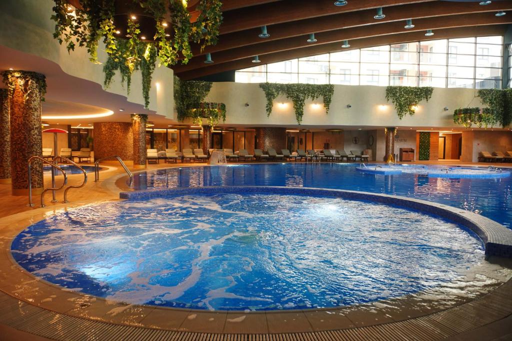 a large swimming pool in a hotel lobby at Hotel Zlatibor in Zlatibor