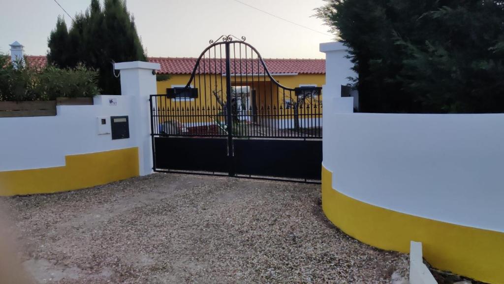 a black and yellow gate with a roller coaster at Quinta Cunte - Casa Sobreiro in São Luis