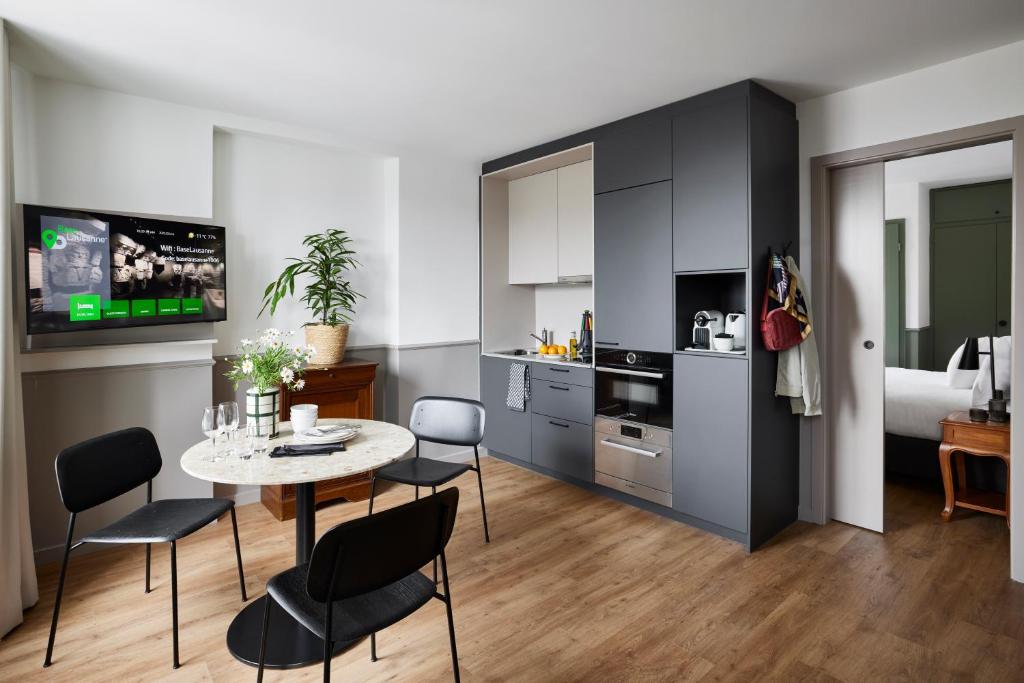 a kitchen and dining room with a table and chairs at Base Lausanne in Lausanne