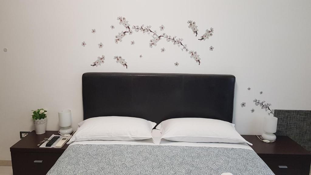 a bedroom with a bed with a black head board at La Lupa in Trastevere in Rome