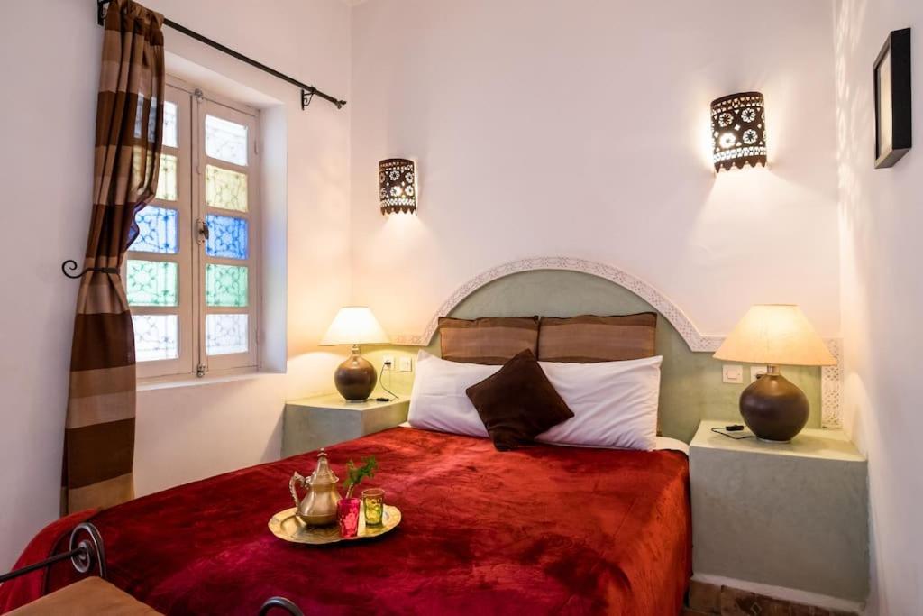 מיטה או מיטות בחדר ב-Riad Al Tainam