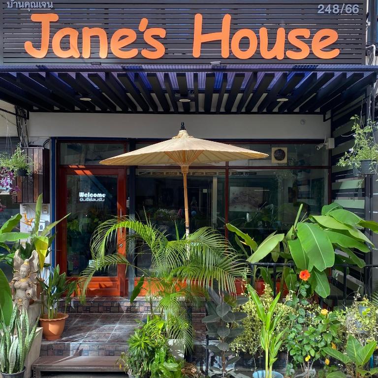 an umbrella in front of a janes house with plants at Jane's House in Chiang Mai