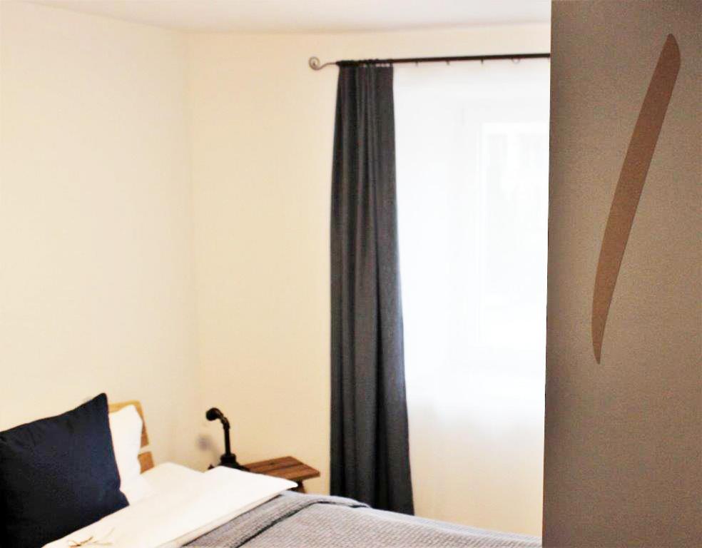 Postel nebo postele na pokoji v ubytování Auberge Passepartout