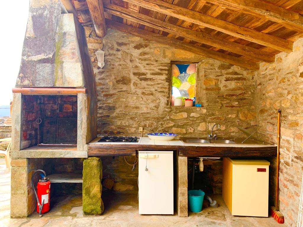 a kitchen with a counter and a sink in a building at Bedousses in Aujac