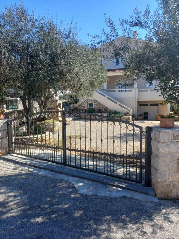 a black fence in front of a house at Apartment Maja in Novalja in Novalja