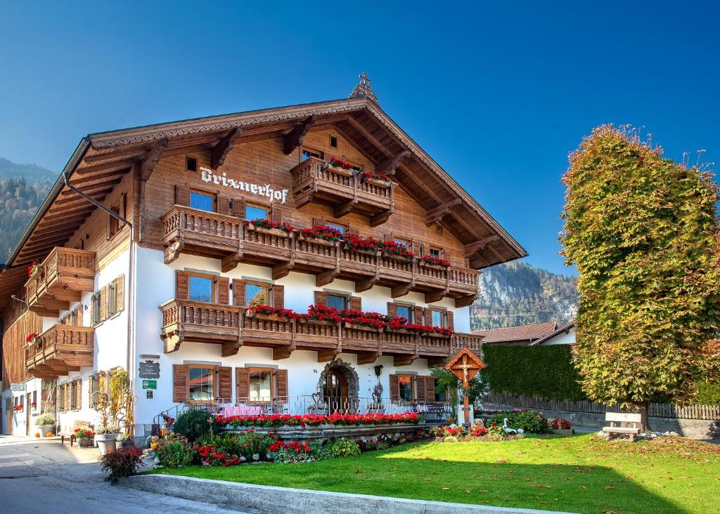 a building with a balcony with flowers on it at Brixnerhof im Zillertal in Schlitters