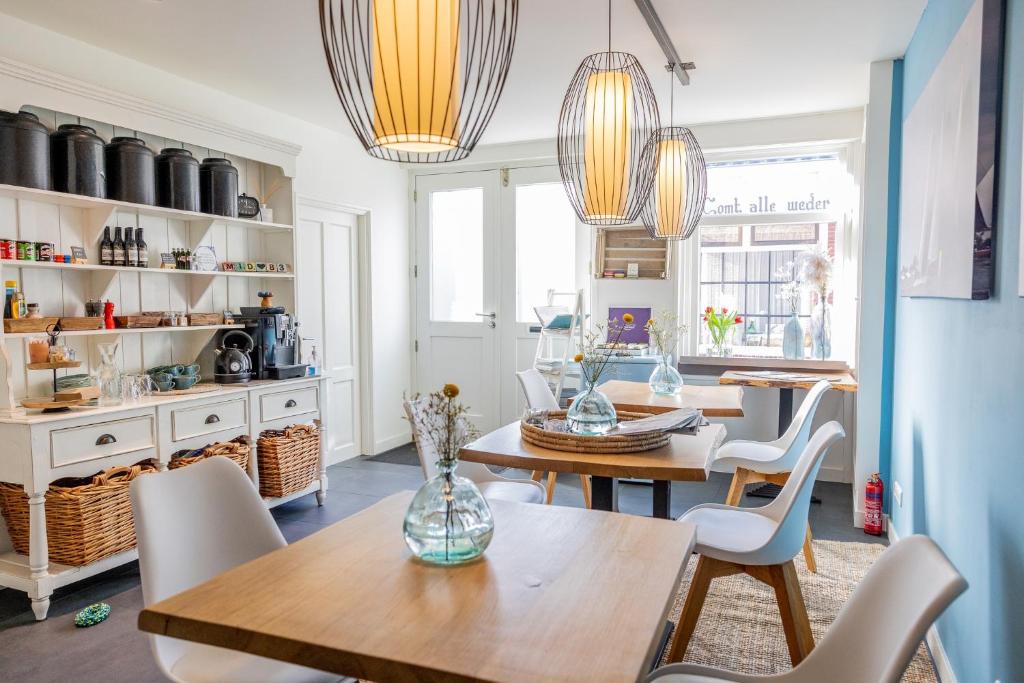 a dining room with two tables and chairs at Mid83 in Woudsend